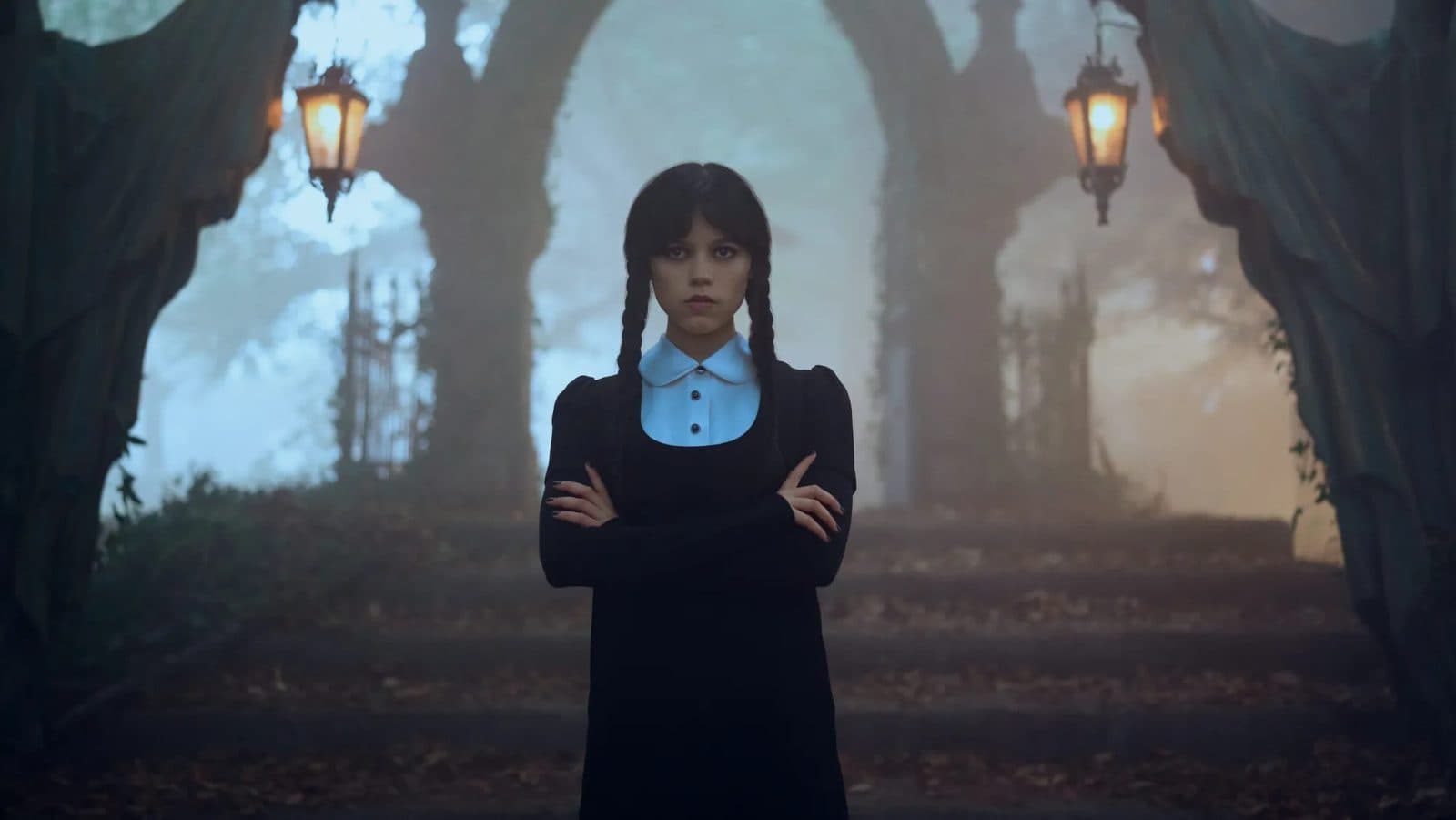 Wednesday Addams in a dim, candlelit hallway